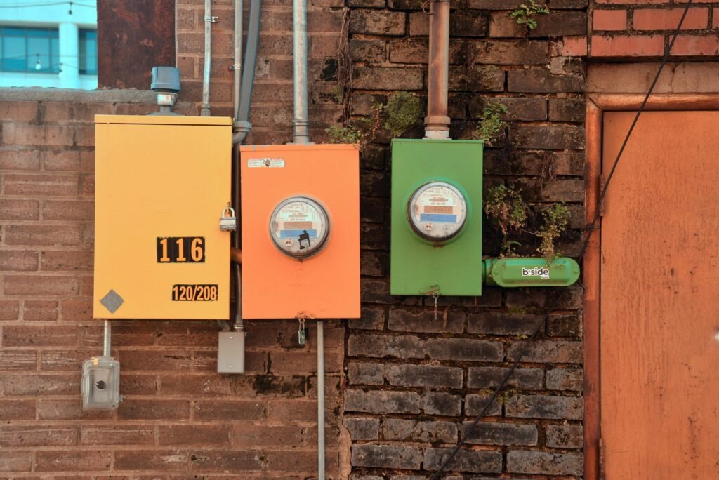 A vibrant display of utility boxes against a brick wall in Texarkana, Texas, showcasing urban infrastructure.