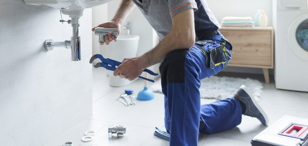 plumber with tools fixing bathroom sink plumber with tools fixing bathroom sink